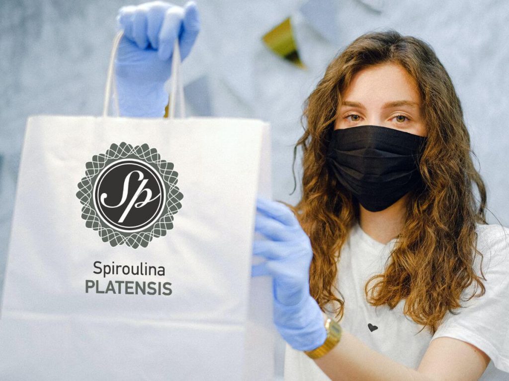 woman with face mask and latex gloves holding a shopping bag spirulina spiroulina platensis