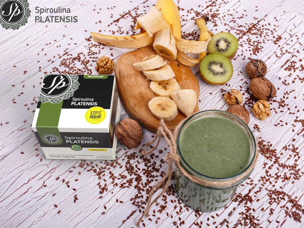 healthy green smoothie with walnut fruits lie table siroulina platensis powder